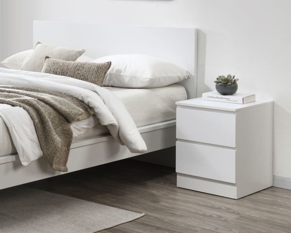 Wooden bed with store white bedside tables