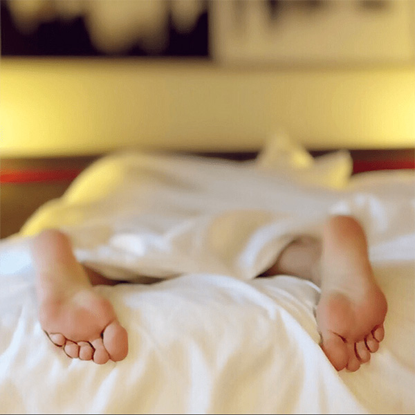 Feet Sticking Out Of The End Of A Bed