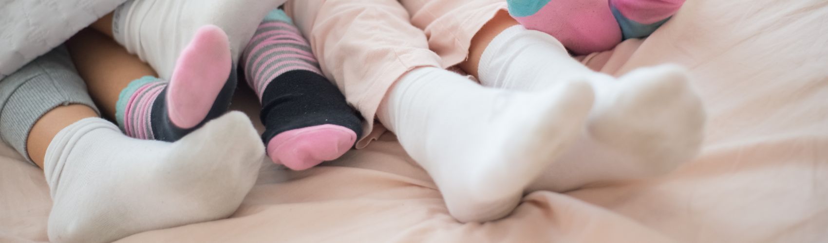 People wearing socks in bed