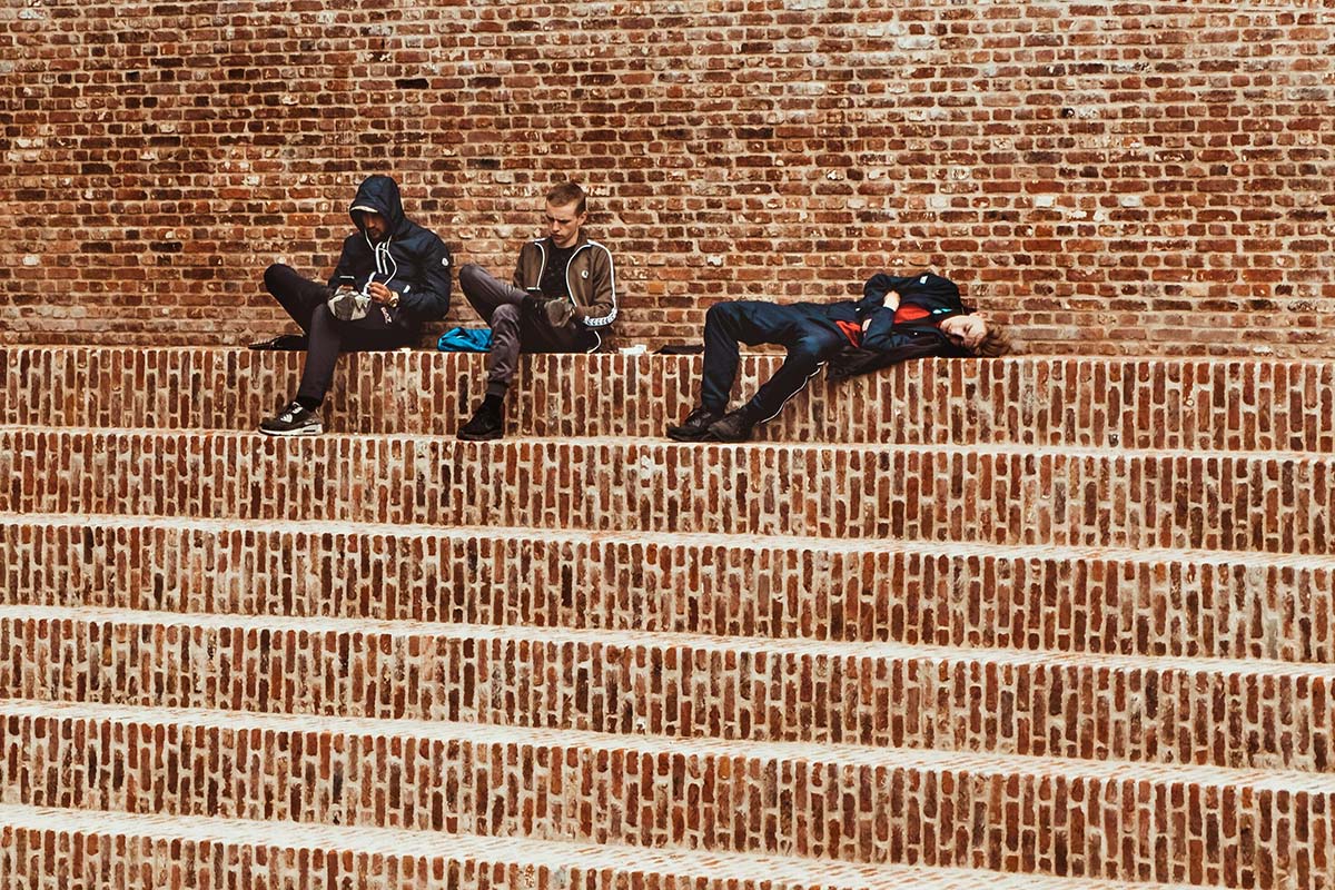 men relaxing on steps