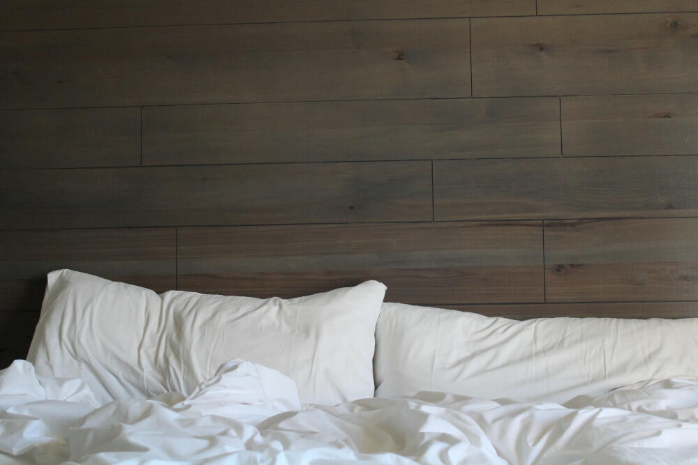White Bed And Brown Wall