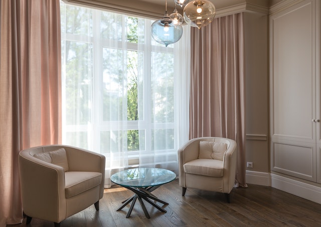 Cosy chairs with large window and curtains