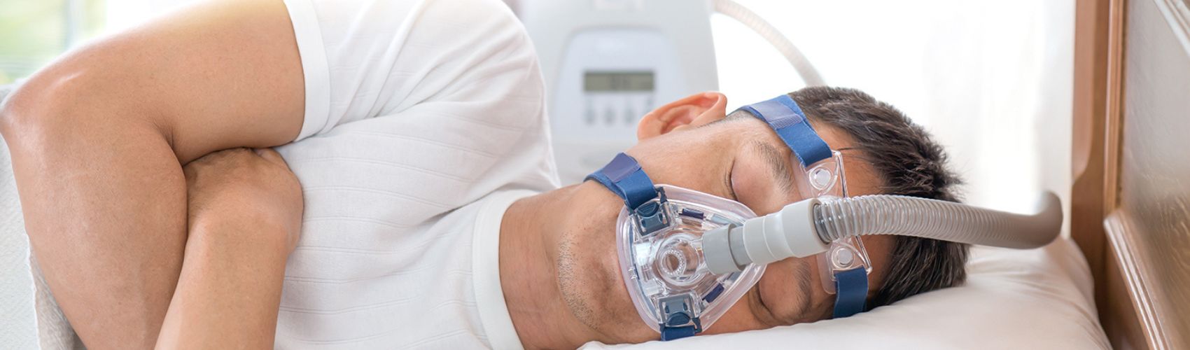 Man sleeping with breathing apparatus