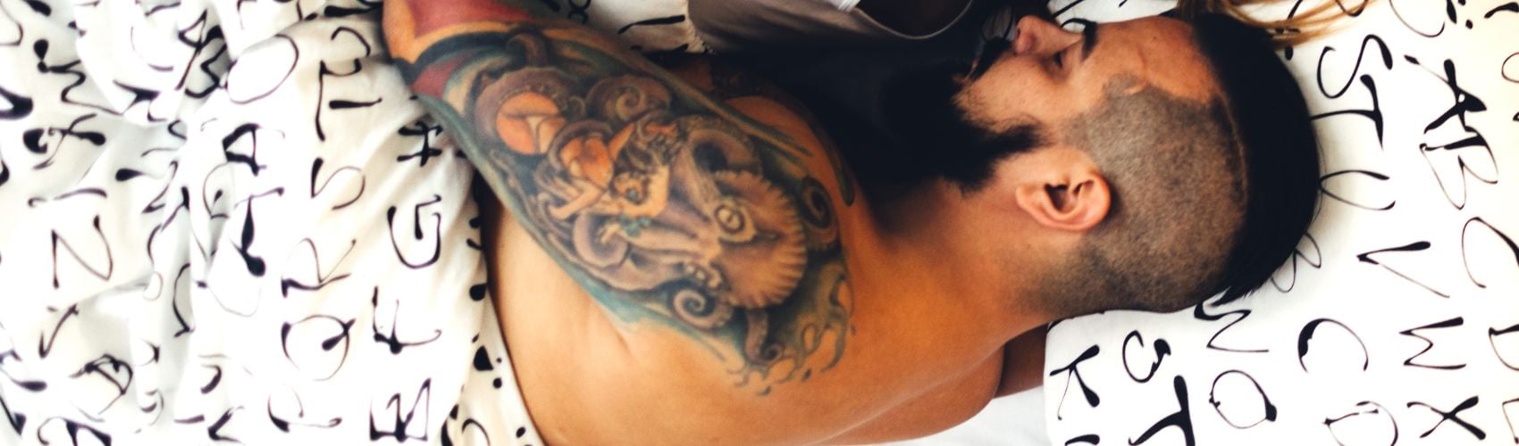 Man with tattoos sleeping